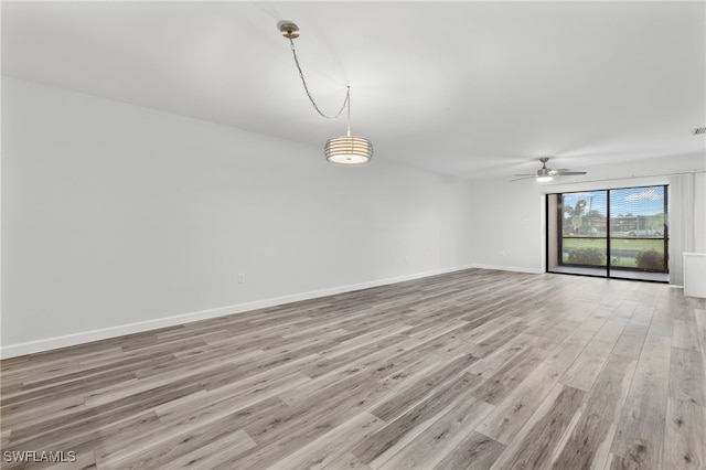 4717 Santa Barbara Blvd Unit G-2, Cape Coral, FL 33914 - empty room featuring light wood-style floors, ceiling fan, and baseboards