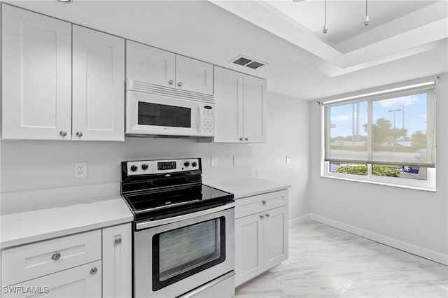 4717 Santa Barbara Blvd Unit G-2, Cape Coral, FL 33914 - kitchen with electric range, white microwave, light marble finish flooring, white cabinetry, and baseboards
