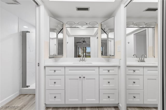 4717 Santa Barbara Blvd Unit G-2, Cape Coral, FL 33914 - full bathroom featuring a marble finish shower, vanity, a ceiling fan, wood finished floors, and baseboards