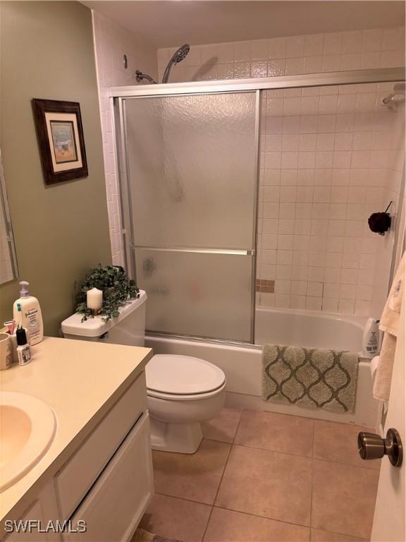 2526 SE 16th Pl Unit 105, Cape Coral, FL 33904 - bathroom with vanity, tile patterned flooring, and combined bath / shower with glass door