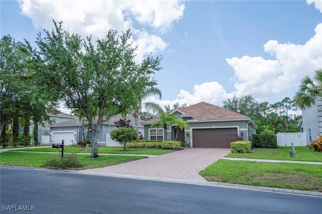 2759 Orange Grove Trl, Naples, FL 34120 - view of front of property with a garage, driveway, and stucco siding