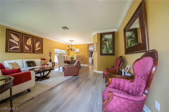 2759 Orange Grove Trl, Naples, FL 34120 - living area featuring a chandelier, wood finished floors, crown molding, baseboards, and arched walkways
