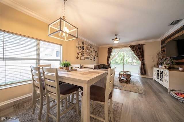 2759 Orange Grove Trl, Naples, FL 34120 - dining room with a chandelier, crown molding, wood finished floors, baseboards, and a ceiling fan