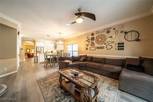 2759 Orange Grove Trl, Naples, FL 34120 - living room with ceiling fan, ornamental molding, wood finished floors, arched walkways, and baseboards