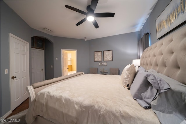 2759 Orange Grove Trl, Naples, FL 34120 - bedroom featuring arched walkways, ceiling fan, and ensuite bath