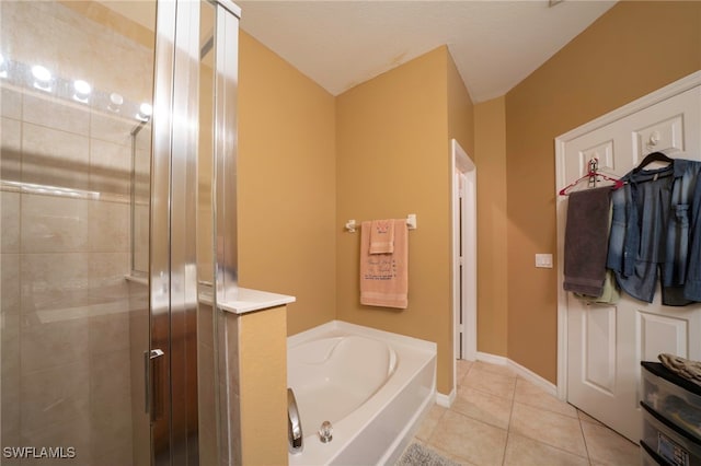 2759 Orange Grove Trl, Naples, FL 34120 - bathroom with a shower stall, a bath, tile patterned floors, and baseboards