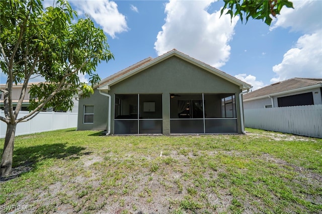 2759 Orange Grove Trl, Naples, FL 34120 - rear view of house featuring a sunroom and stucco siding