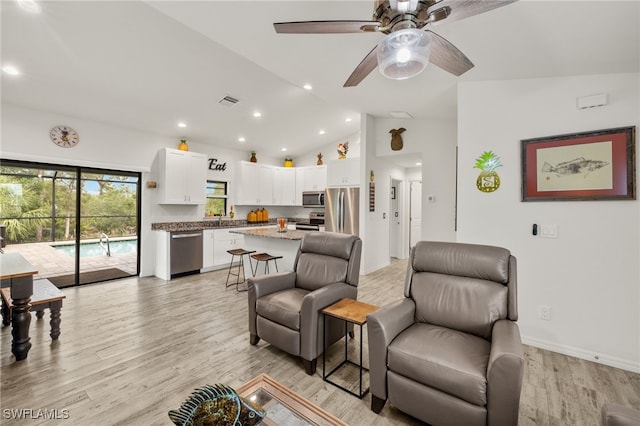 3901 NW 48th Ter, Cape Coral, FL 33993 - living area featuring vaulted ceiling, light wood finished floors, ceiling fan, recessed lighting, and baseboards