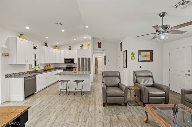3901 NW 48th Ter, Cape Coral, FL 33993 - living room with vaulted ceiling, light wood-style floors, a ceiling fan, recessed lighting, and baseboards