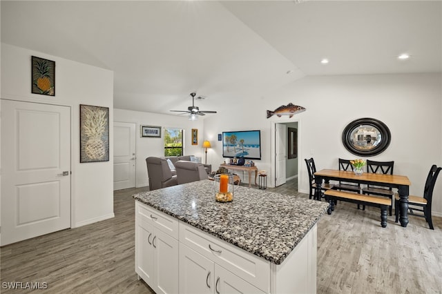 3901 NW 48th Ter, Cape Coral, FL 33993 - kitchen with a center island, a ceiling fan, dark stone counters, lofted ceiling, and light wood-style flooring