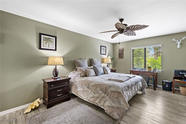 3901 NW 48th Ter, Cape Coral, FL 33993 - bedroom with baseboards, wood finished floors, and a ceiling fan