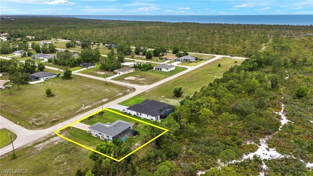 3901 NW 48th Ter, Cape Coral, FL 33993 - aerial perspective of suburban area with property boundaries highlighted, a heavily wooded area, and a nearby body of water