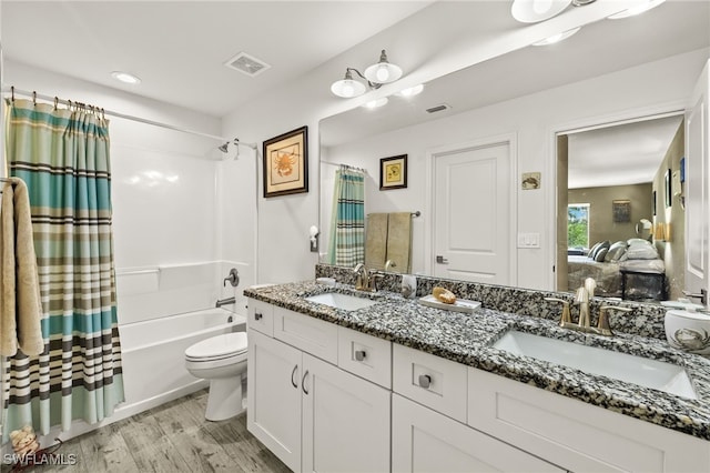 3901 NW 48th Ter, Cape Coral, FL 33993 - ensuite bathroom with shower / bath combination with curtain, double vanity, toilet, and wood finished floors