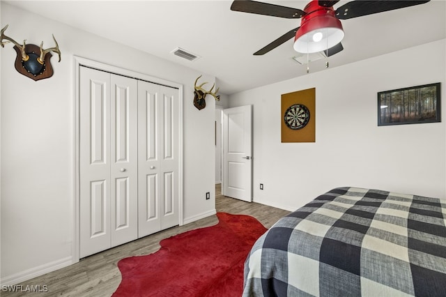 3901 NW 48th Ter, Cape Coral, FL 33993 - bedroom with wood finished floors, baseboards, a ceiling fan, and a closet