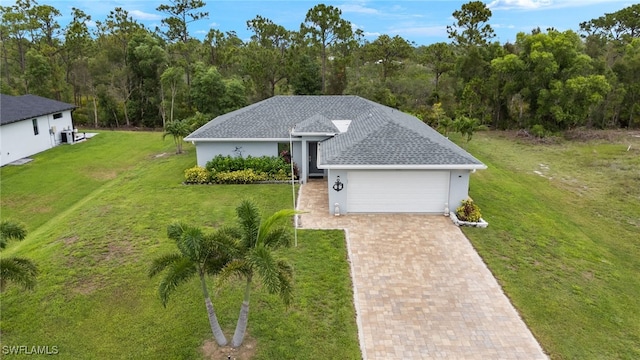3901 NW 48th Ter, Cape Coral, FL 33993 - view of front facade with decorative driveway, a garage, a front lawn, and stucco siding