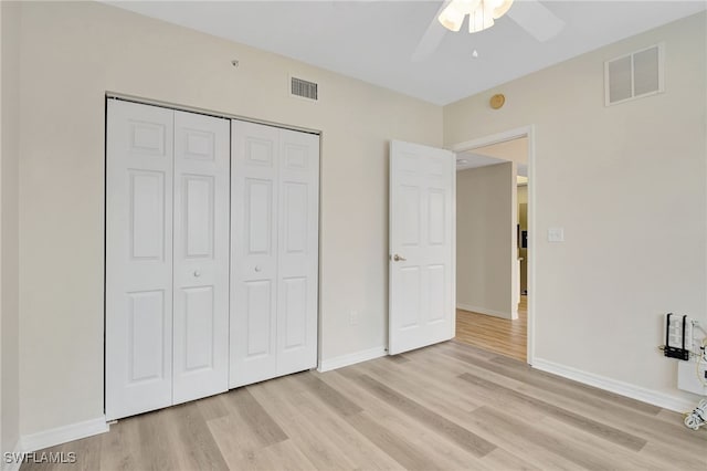 4040 Durango Ct Unit 101, Estero, FL 33928 - unfurnished bedroom featuring light wood finished floors, a closet, baseboards, and ceiling fan