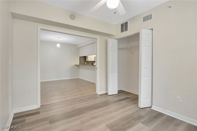4040 Durango Ct Unit 101, Estero, FL 33928 - unfurnished bedroom featuring wood finished floors, baseboards, a closet, and ceiling fan