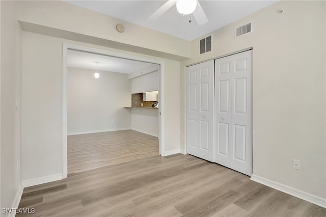 4040 Durango Ct Unit 101, Estero, FL 33928 - unfurnished living room featuring ceiling fan, wood finished floors, and baseboards
