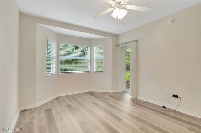 4040 Durango Ct Unit 101, Estero, FL 33928 - unfurnished room featuring light wood-style flooring, baseboards, a ceiling fan, and a smoke detector