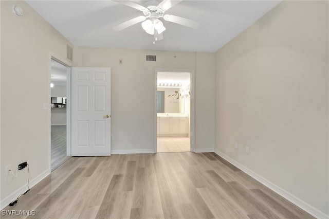 4040 Durango Ct Unit 101, Estero, FL 33928 - unfurnished bedroom with light wood finished floors, baseboards, ensuite bathroom, and ceiling fan
