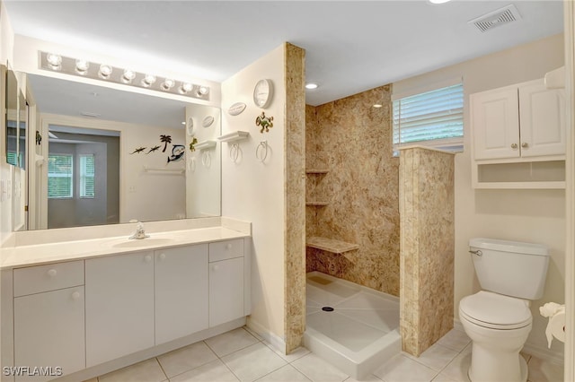 4040 Durango Ct Unit 101, Estero, FL 33928 - bathroom with vanity, tile patterned flooring, walk in shower, and toilet