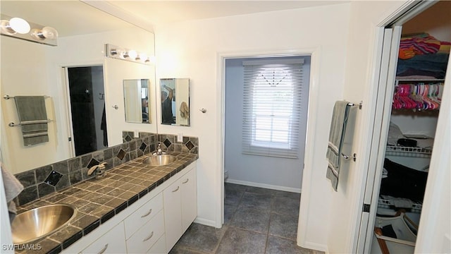 2780 39th St SW, Naples, FL 34117 - bathroom featuring double vanity, a spacious closet, and tile patterned flooring