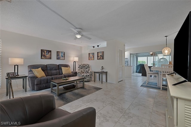 7400 College Pkwy Unit 61B, Fort Myers, FL 33907 - living area with light marble finish floors, a ceiling fan, a textured ceiling, and baseboards