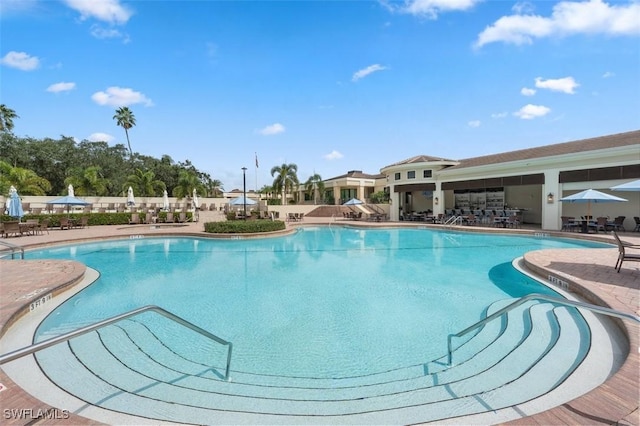 605 El Camino Real Unit 102, Naples, FL 34119 - community pool featuring a patio