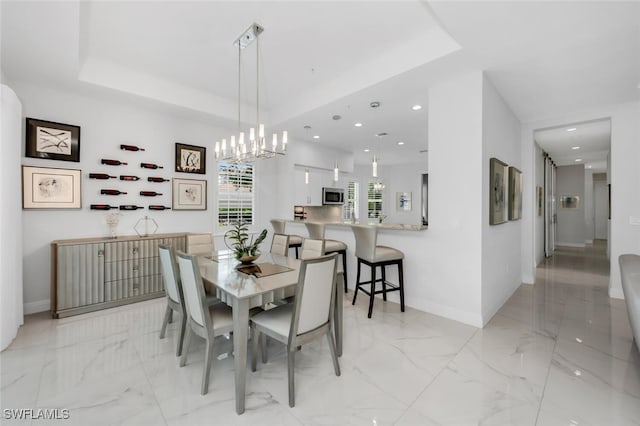 605 El Camino Real Unit 102, Naples, FL 34119 - dining area featuring recessed lighting, baseboards, light marble finish flooring, a tray ceiling, and a chandelier