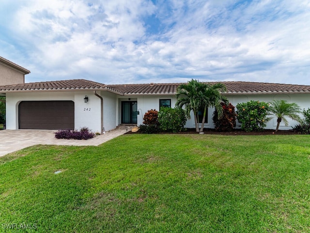 242 Angler Ct, Marco Island, FL 34145 - mediterranean / spanish-style house featuring concrete driveway, a garage, stucco siding, a tiled roof, and a front lawn