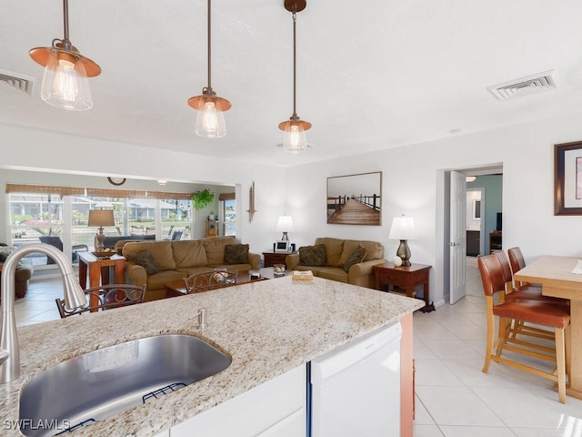 242 Angler Ct, Marco Island, FL 34145 - kitchen with a sink, dishwasher, light tile patterned floors, and decorative light fixtures