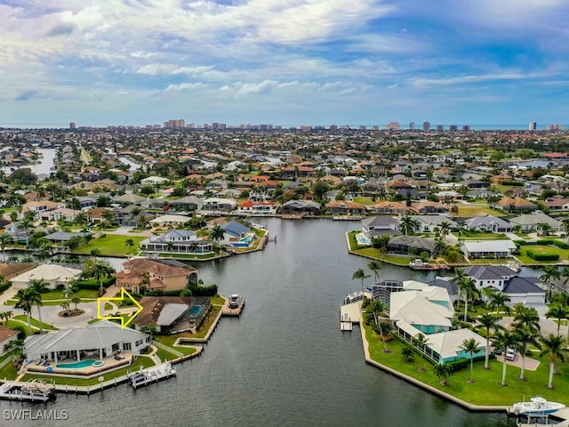 242 Angler Ct, Marco Island, FL 34145 - aerial perspective of suburban area with a large body of water and city skyline