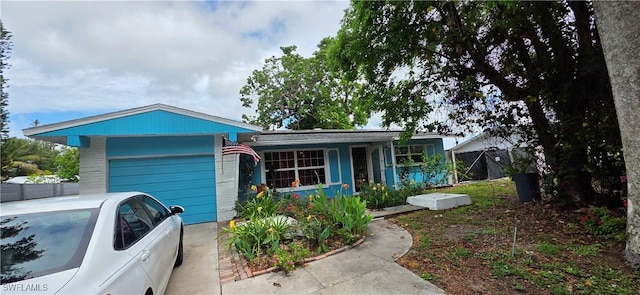 2027 44th St SW, Naples, FL 34116 - view of front facade featuring an attached garage and concrete driveway