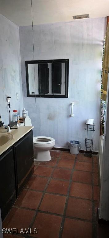 2027 44th St SW, Naples, FL 34116 - bathroom featuring vanity, toilet, and tile patterned flooring