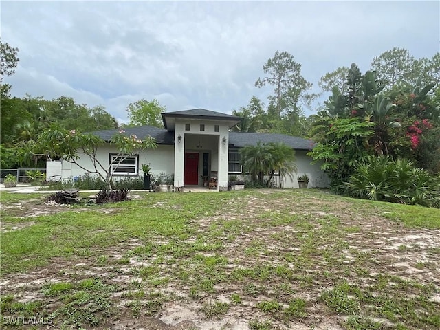 260 29th St SW, Naples, FL 34117 - view of front of property featuring stucco siding and a front lawn