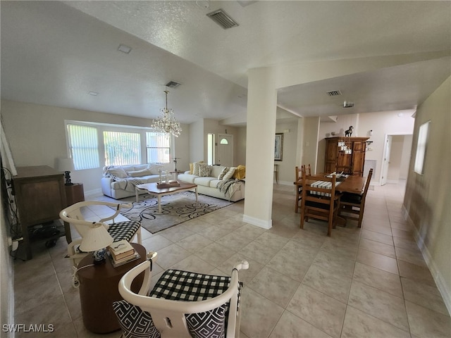 260 29th St SW, Naples, FL 34117 - living room with a chandelier, light tile patterned flooring, and baseboards