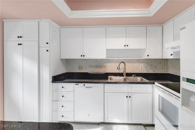1155 Sandpiper St Unit D4, Naples, FL 34102 - kitchen with white appliances, white cabinets, dark countertops, a raised ceiling, and decorative backsplash