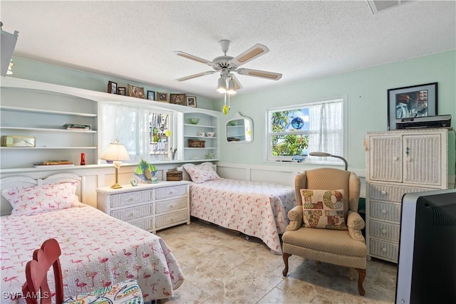 2839 Janet St, Matlacha, FL 33993 - bedroom featuring a textured ceiling, a decorative wall, and ceiling fan