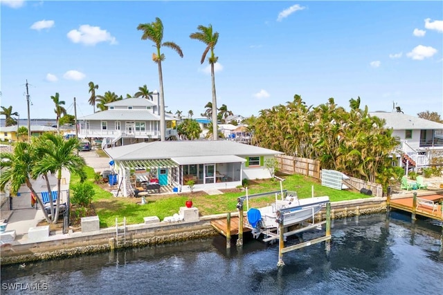 2839 Janet St, Matlacha, FL 33993 - back of property with boat lift, a water view, and a sunroom