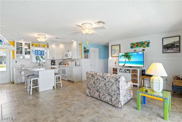 2839 Janet St, Matlacha, FL 33993 - living room with ceiling fan and a textured ceiling