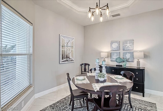 623 SW 56th St, Cape Coral, FL 33914 - dining room with light marble finish floors, plenty of natural light, a tray ceiling, and ornamental molding