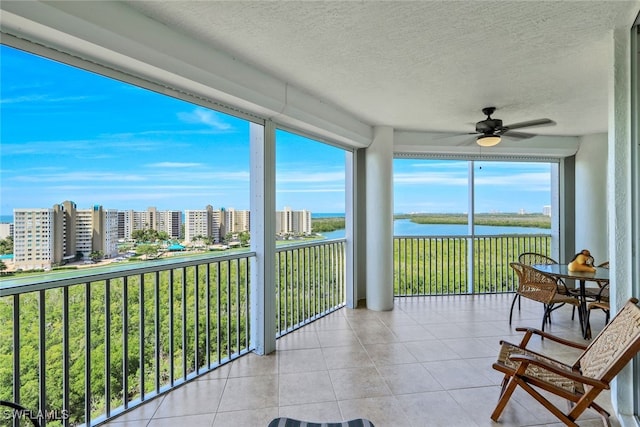 315 Dunes Blvd Unit 1006, Naples, FL 34110 - sunroom / solarium with a water view, tile patterned floors, and a textured ceiling