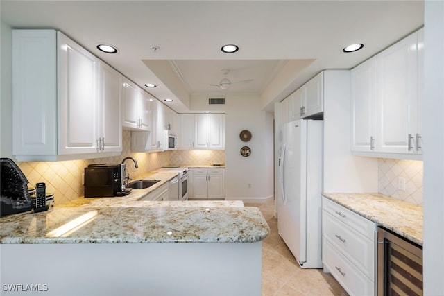 315 Dunes Blvd Unit 1006, Naples, FL 34110 - kitchen with white appliances, wine cooler, a sink, decorative backsplash, and recessed lighting