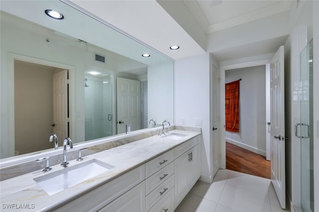 315 Dunes Blvd Unit 1006, Naples, FL 34110 - full bathroom with crown molding, double vanity, a shower stall, tile patterned flooring, and recessed lighting