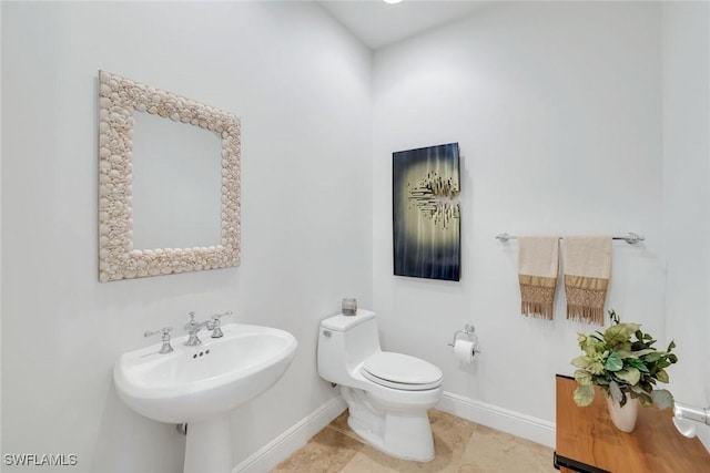 1050 Borghese Ln Unit 106, Naples, FL 34114 - half bathroom featuring baseboards, toilet, and tile patterned flooring