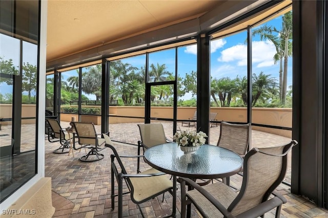 1050 Borghese Ln Unit 106, Naples, FL 34114 - sunroom / solarium featuring brick floors