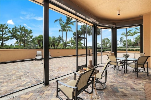 1050 Borghese Ln Unit 106, Naples, FL 34114 - sunroom / solarium with brick flooring and a textured ceiling