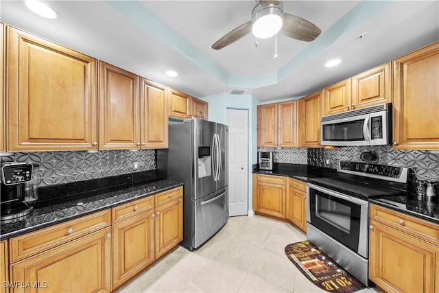 2745 1st St Unit 801, Fort Myers, FL 33916 - kitchen with stainless steel appliances, light tile patterned flooring, decorative backsplash, dark stone countertops, and recessed lighting
