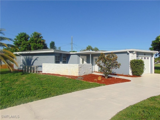 100 Waterview Ave, Lehigh Acres, FL 33936 - view of front facade with driveway, an attached garage, stone siding, a front yard, and stucco siding