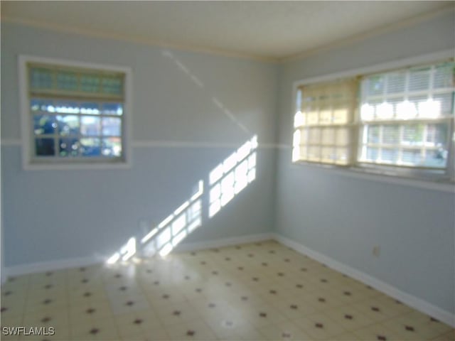 100 Waterview Ave, Lehigh Acres, FL 33936 - unfurnished room with baseboards, tile patterned floors, and ornamental molding